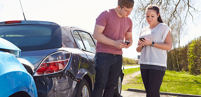 People exchanging information following an auto accident