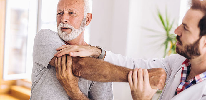 Elderly man receiving shoulder adjustment from San Ramon chiropractor