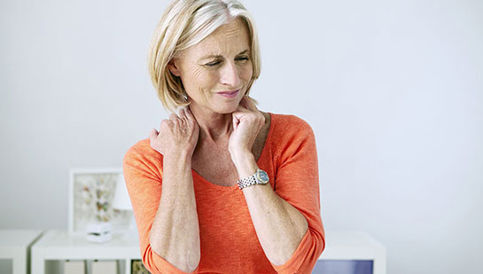 Mature woman suffering from neck and shoulder pain before visiting San Ramon chiropractor