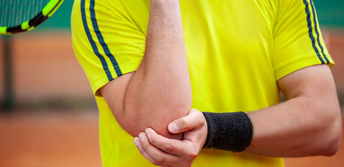 Man with tennis elbow before chiropractic treatment from San Ramon chiropractor